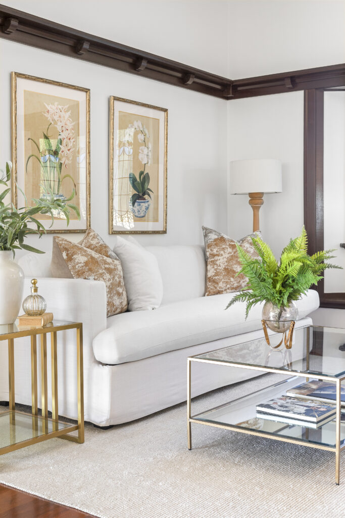 Luxury living room with a white sofa and gold accents