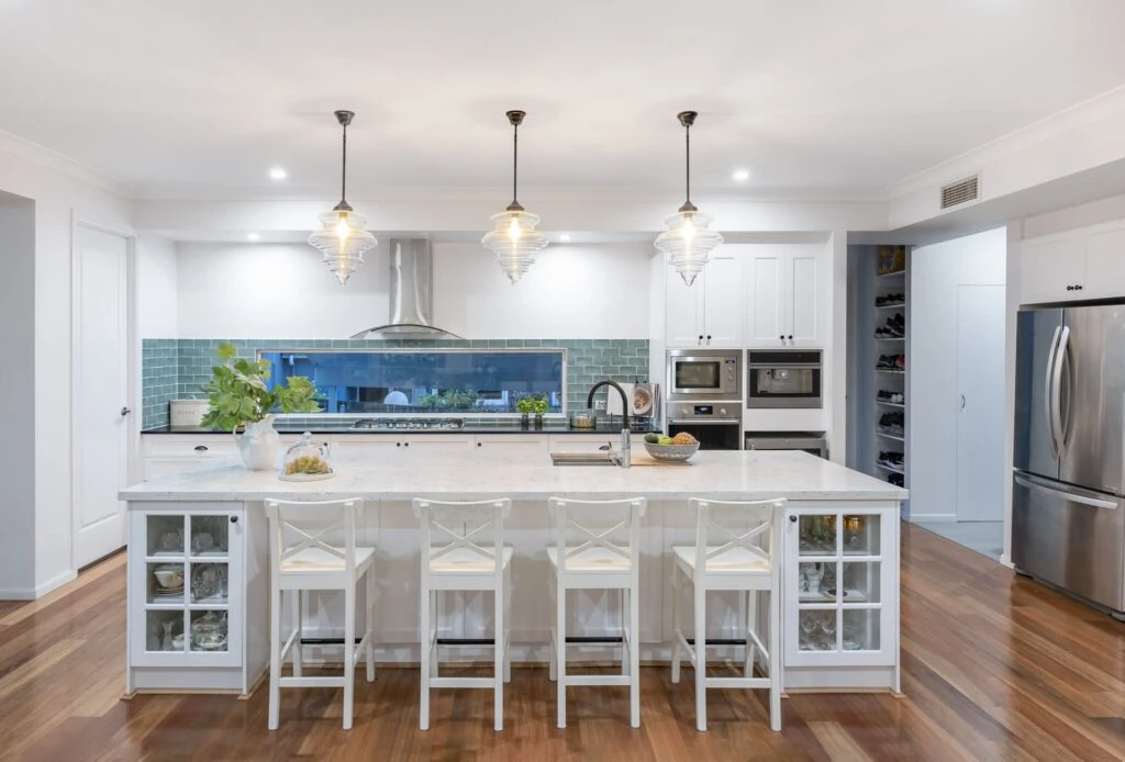 Modern white kitchen with a chrome fridge freezer