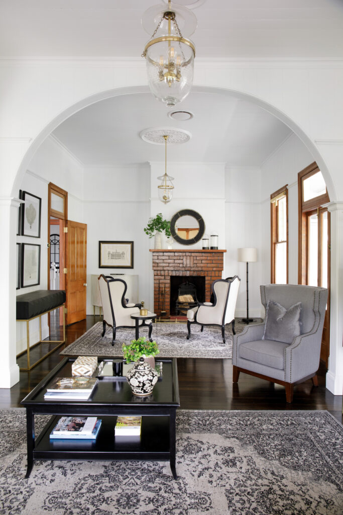 Seating area in a white room with a brick fireplace.
