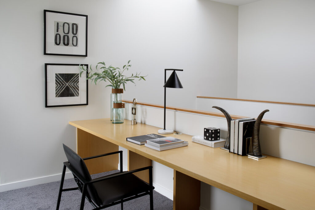Long wooden desk area with black and white accents