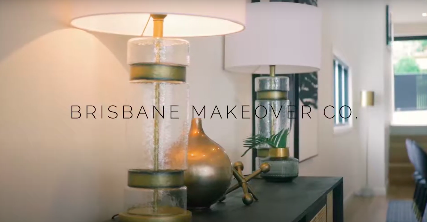 Brisbane Makover Co. Logo over a photo of a side table in a modern home