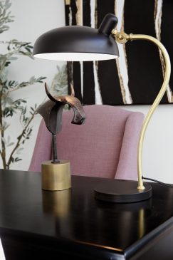 Black and gold desk lamp and a pink chair