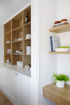 Wooden shelving and white units and walls