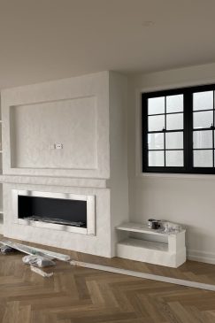 Empty living room with a space for a television above a fireplace