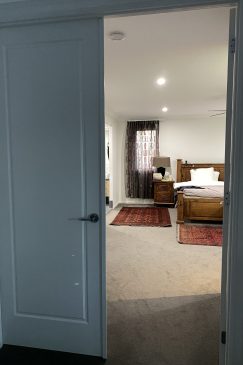 View through an open door to a bedroom