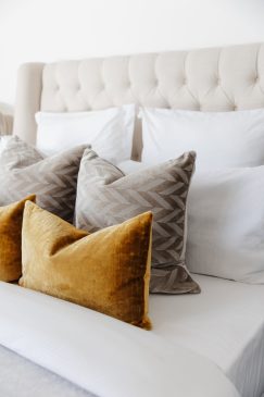 A crisp white bed styled to perfection in a modern home