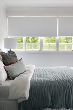 Calming blues and whites in a modern wood-panelled bedroom