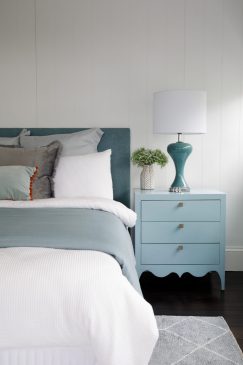 Calming blues and whites in a modern wood-panelled bedroom