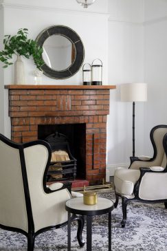 A black and white aesthetic sitting room with a brick fireplace