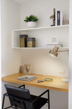 White and wood desk area with table lamp