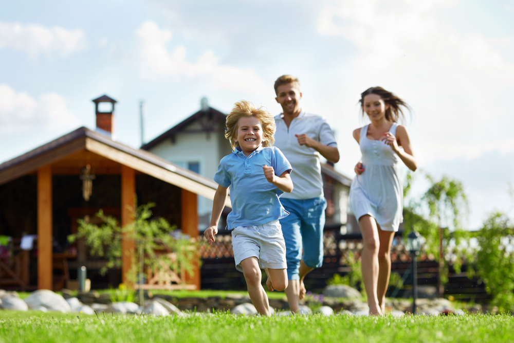 People running on a lawn at the house