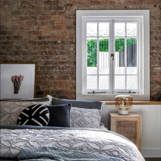 Bedroom with brick wall